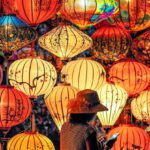 Cultures - Two Person Standing Near Assorted-color Paper Lanterns