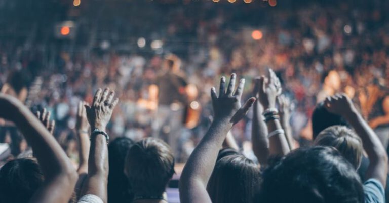 Event - Group of People Raise Their Hands on Stadium