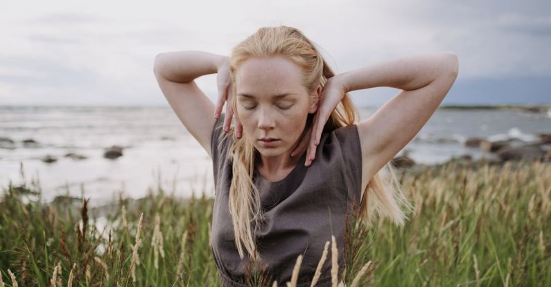 Movements - A Woman Dancing on the Field with Her Eyes Closed