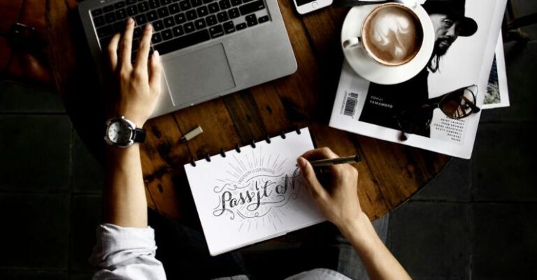 Designers - Person Sitting Facing Laptop Computer With Sketch Pad