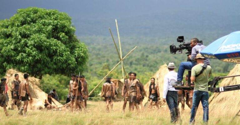 Documentary - People at the Green Grass Field With the Distance Holding Filming Camera during Day Time